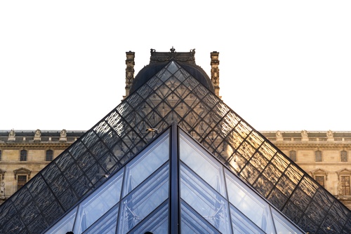 Louvre,Museum,Glass,Pyramid,Contrasting,With,Historic,Palace,Architecture,Against