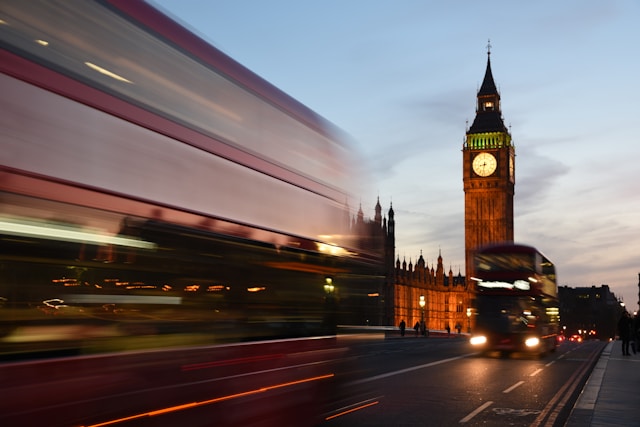 A red London bus on a city street